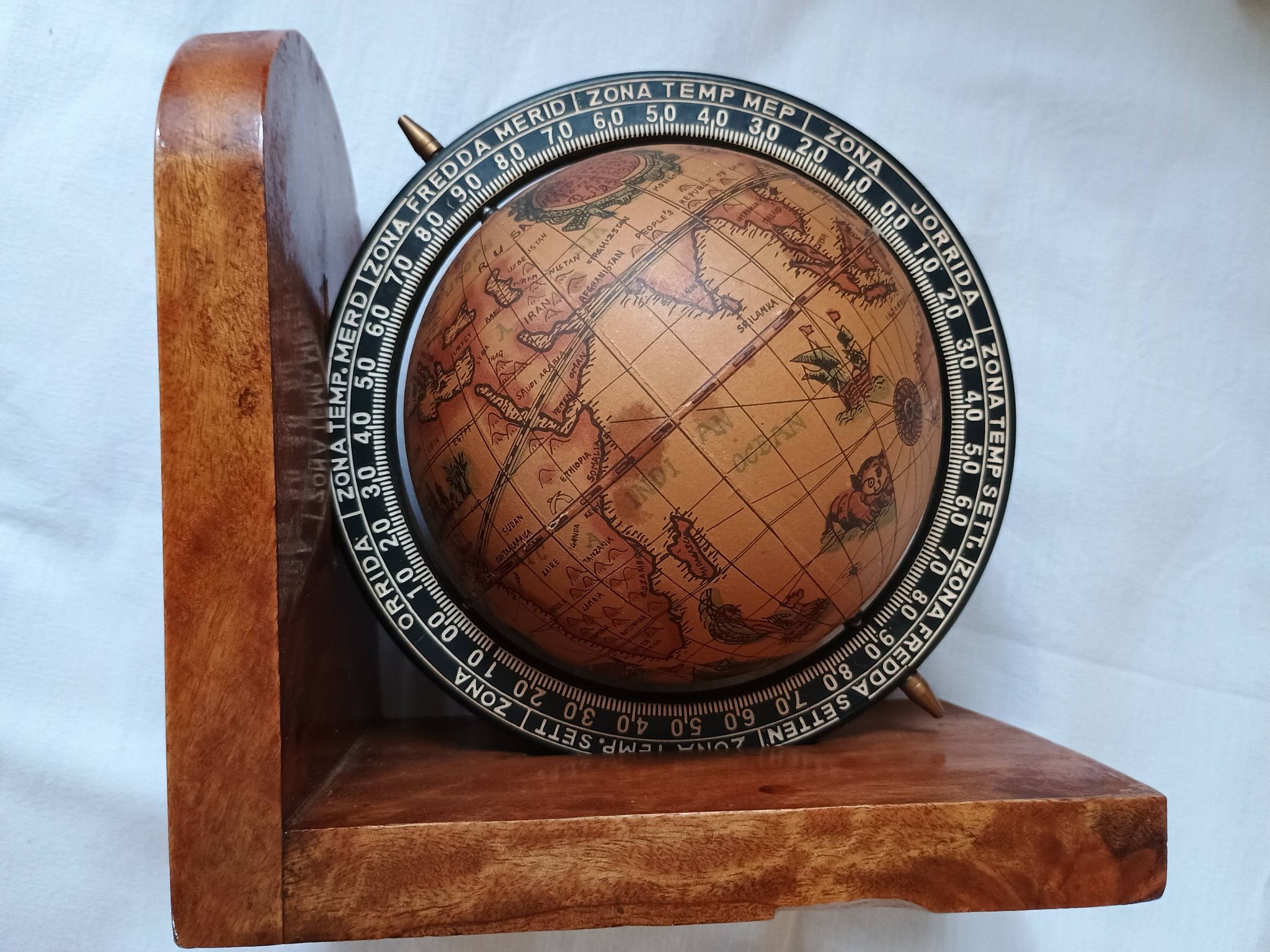Pair of vintage bookends with rotating terrestrial globes on wooden bases in Spain