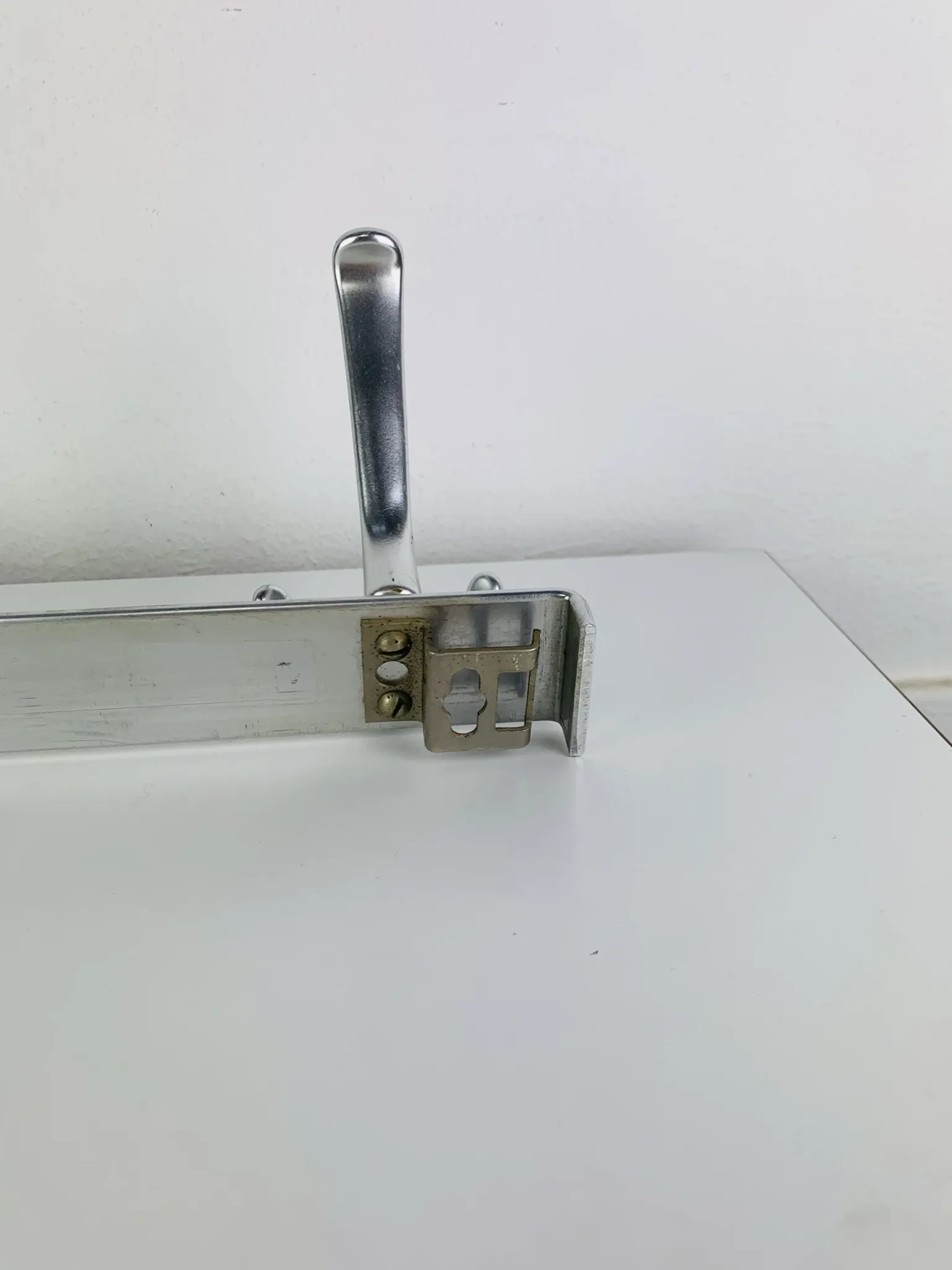 Wall-mounted coat rack, strip of 3 aluminium hooks from the 1960s.