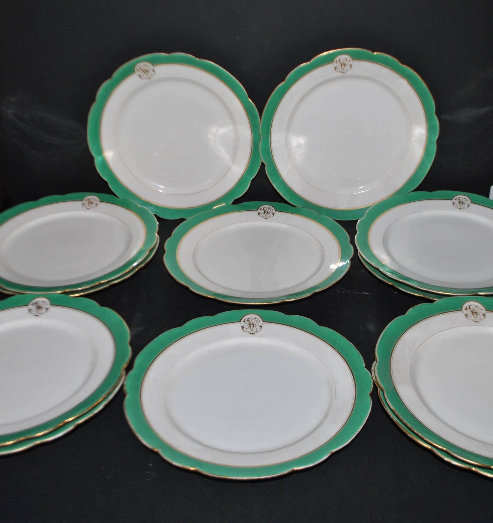 Paris porcelain set of 12 flat plates with green border and gold monogram JC.