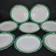 Paris porcelain set of 12 flat plates with green border and gold monogram JC.
