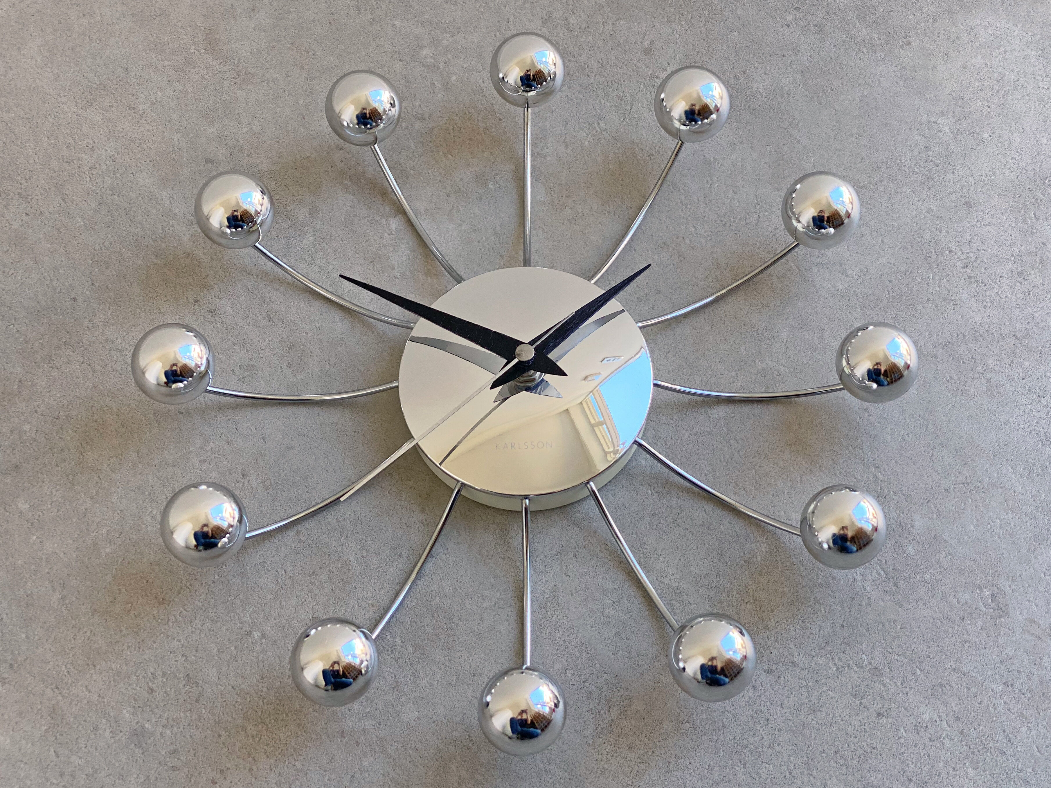 Chrome Karlsson spider wall clock with black hands, sputnik space age