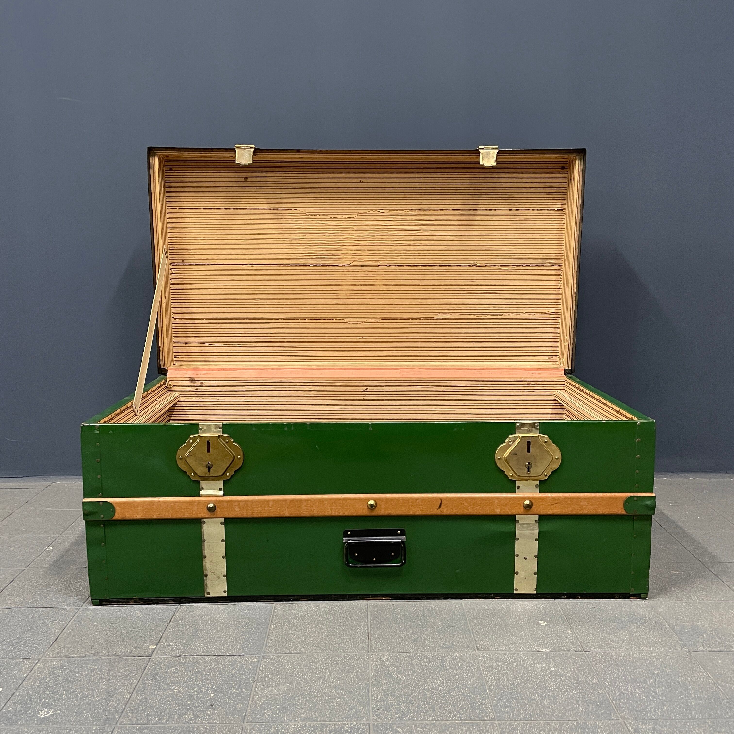Green metal trunk with wooden sleds