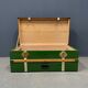 Green metal trunk with wooden sleds