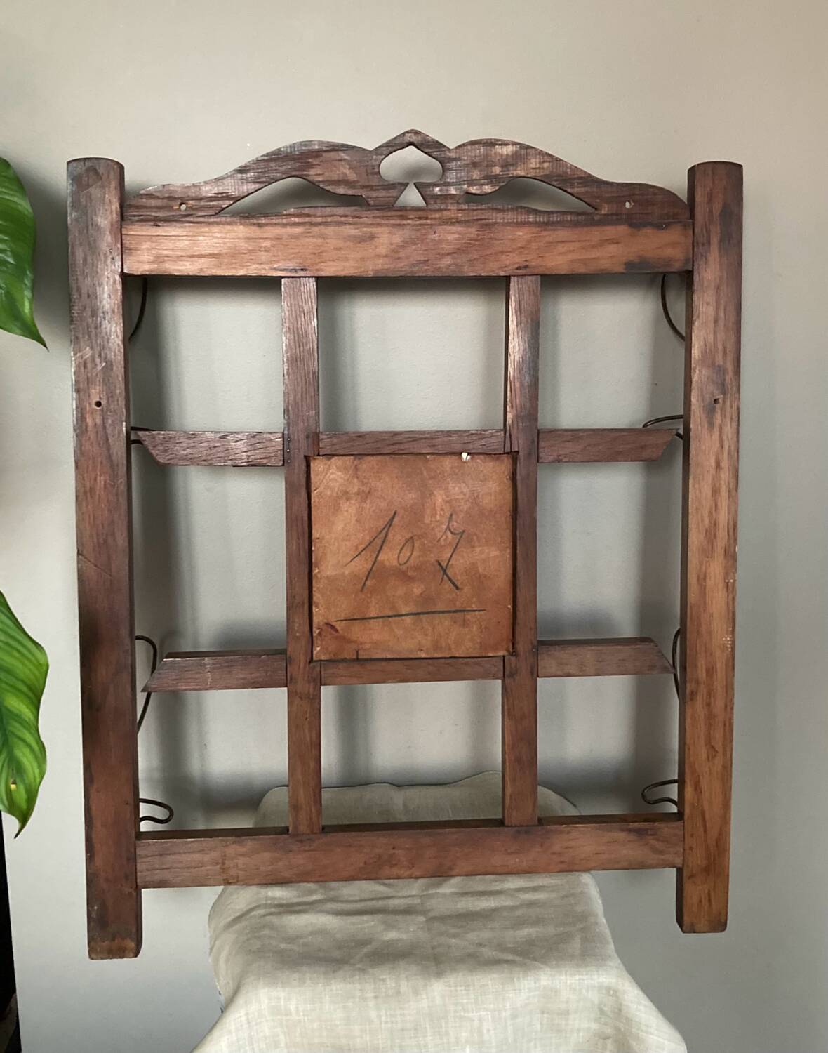 Art Deco wall-mounted coat rack in oak, early 20th century. Beveled central mirror