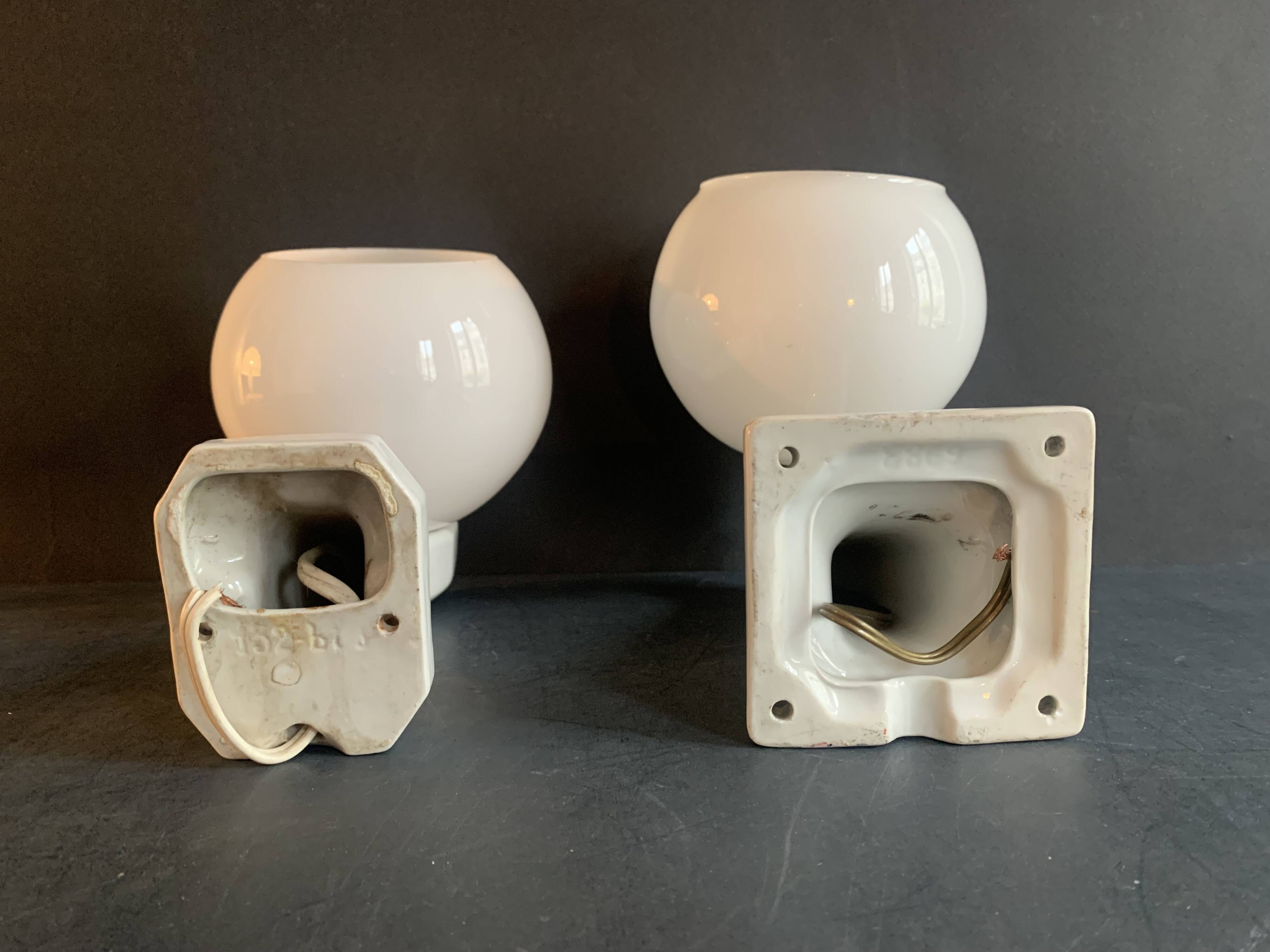 Pair of Art Deco porcelain wall lights with white Opaline globes, 1920