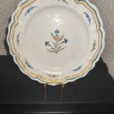 Old plate in earthenware of Nevers eighteenth Century with chantourné edges