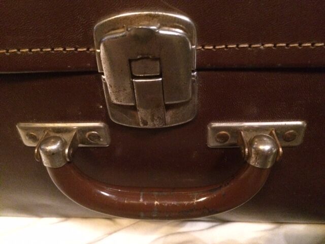 Suitcase vintage leather inside and brown carpeted home