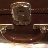 Suitcase vintage leather inside and brown carpeted home
