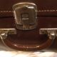 Suitcase vintage leather inside and brown carpeted home