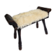 Carved wooden stool covered with Celtic-style sheepskin