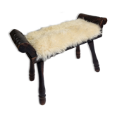 Carved wooden stool covered with Celtic-style sheepskin