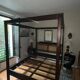 Exotic wood four-poster bed colonial style with rattan headboard
