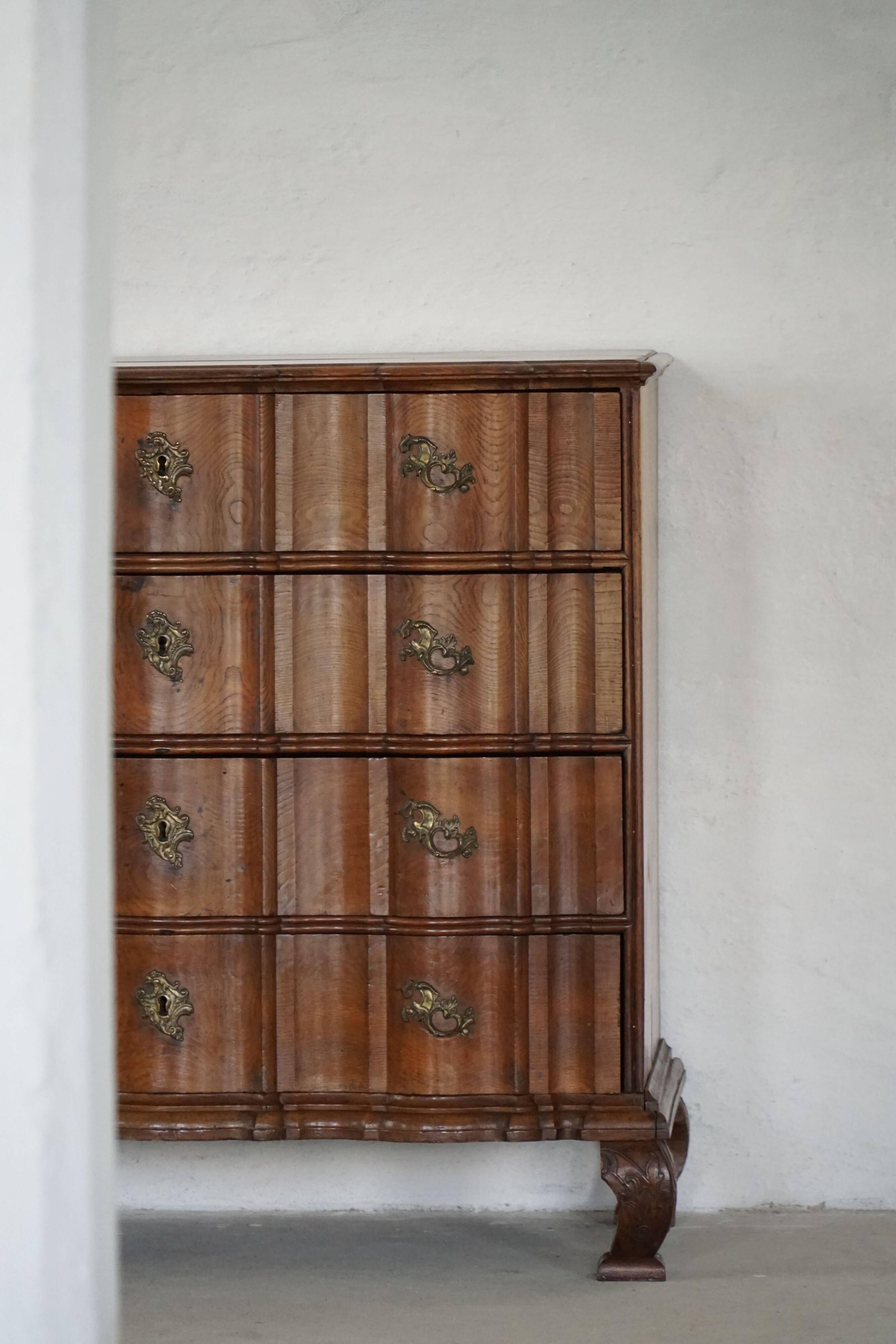 Antique baroque oak commode from the late 18th century with cabriole legs.