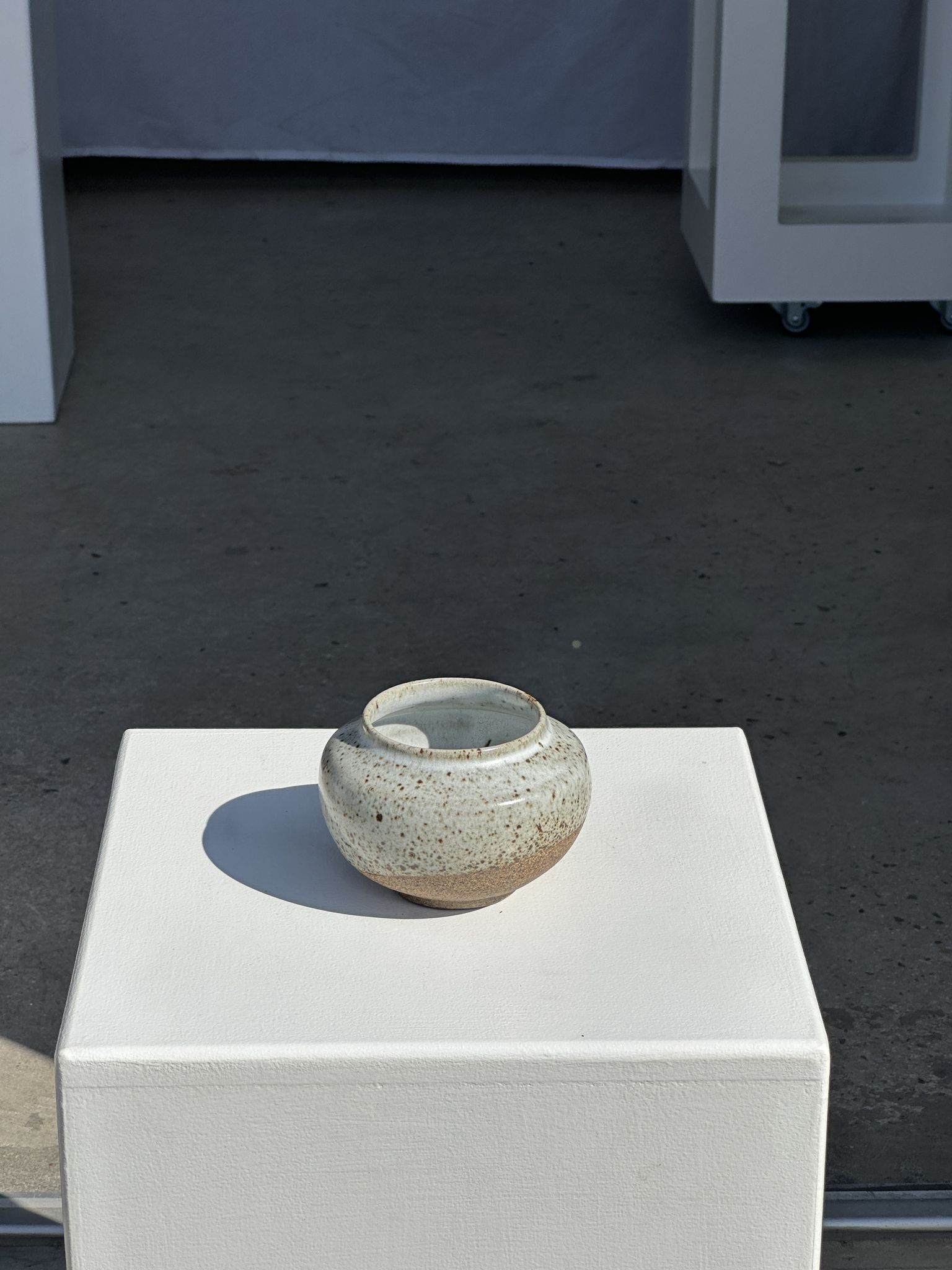 Small white ball vase tight neck in glazed speckled ceramic