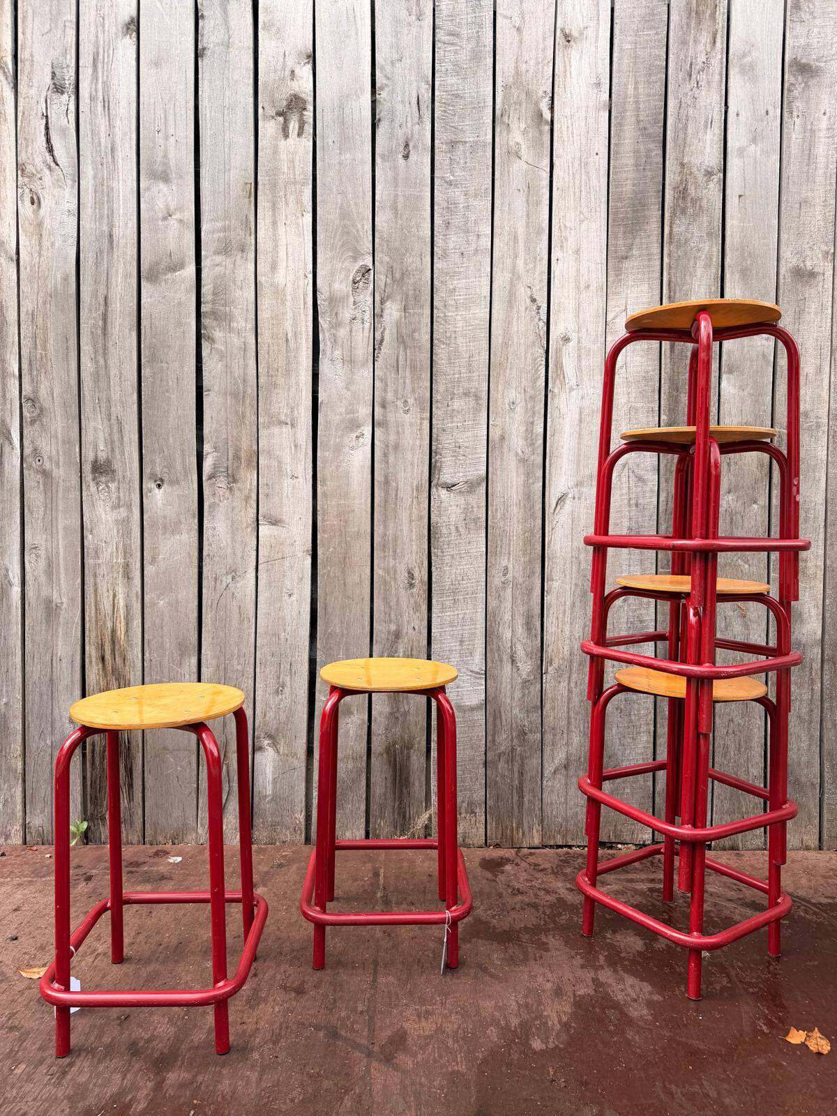 Vintage red industrial stool with a wooden seat, 1960s.