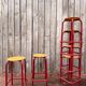 Vintage red industrial stool with a wooden seat, 1960s.