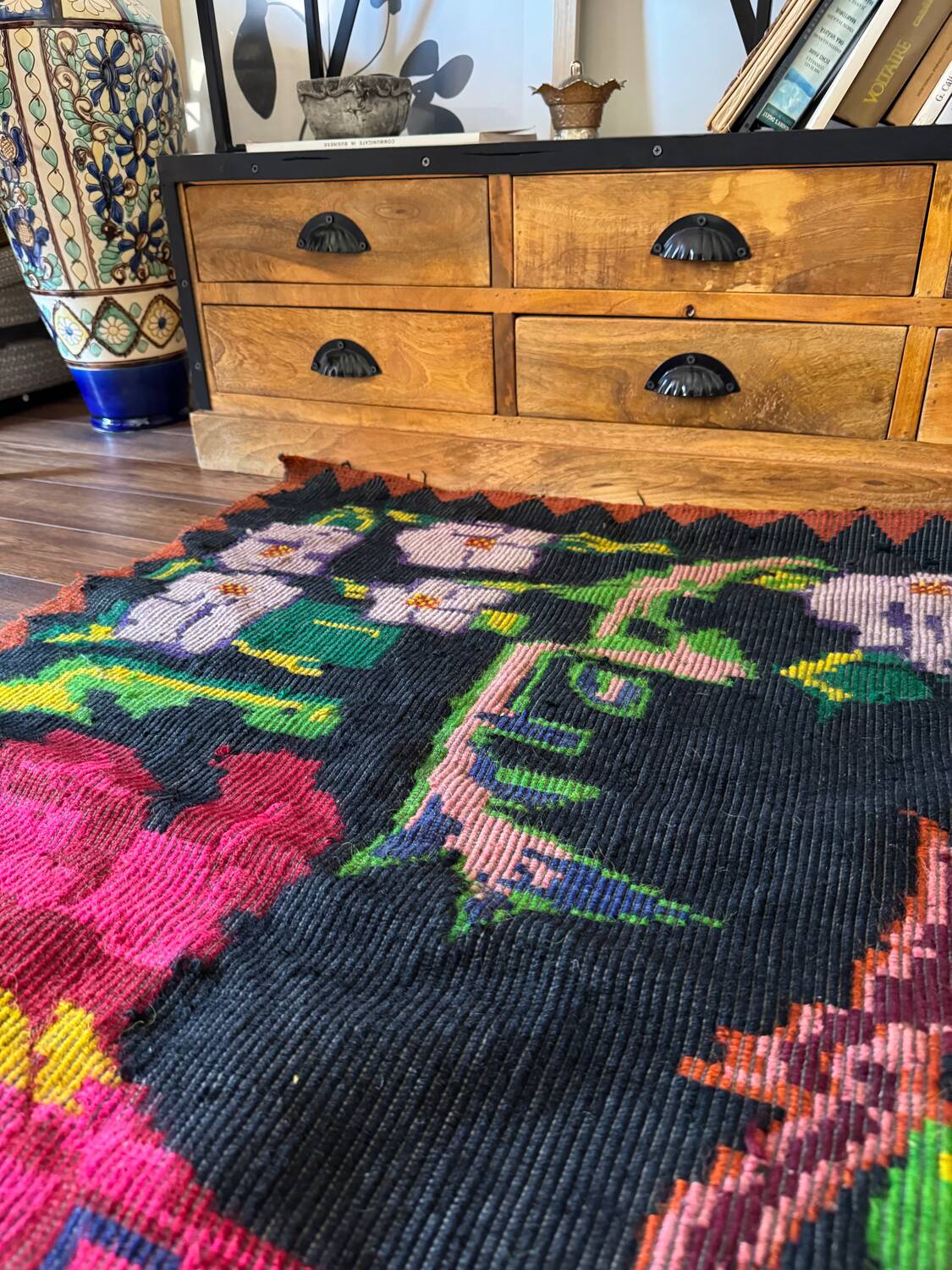 Bohemian floral design, handwoven wool rug, black background with colorful flowers