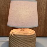 Oval table lamp in handcrafted ceramic with draped effect.