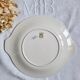 7 mismatched antique dessert plates accompanied by a pie dish