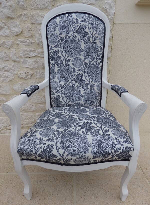 Voltaire style armchair covered in floral fabric in quality aged wood