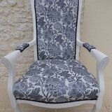 Voltaire style armchair covered in floral fabric in quality aged wood