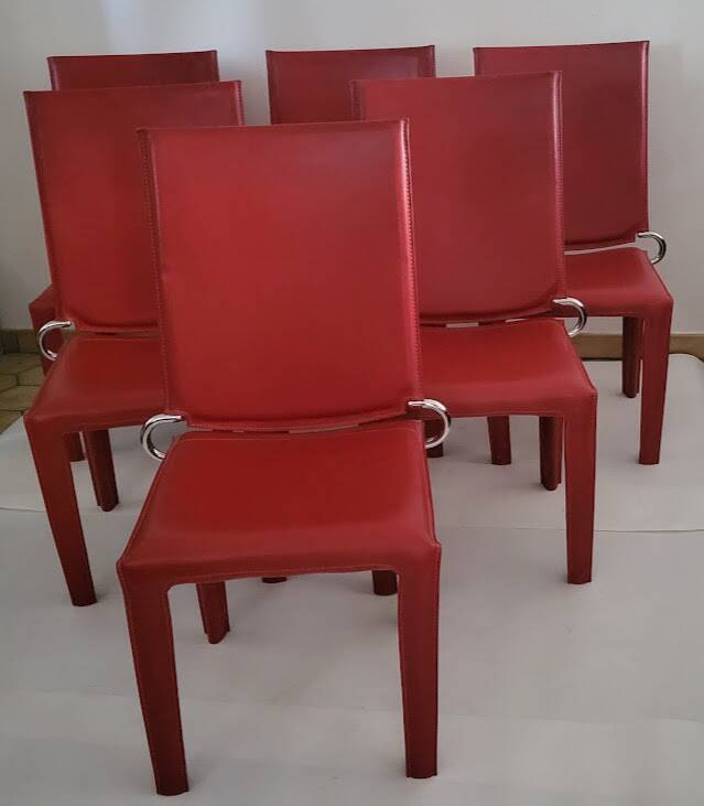Red leather dining chairs by Arper