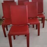 Red leather dining chairs by Arper