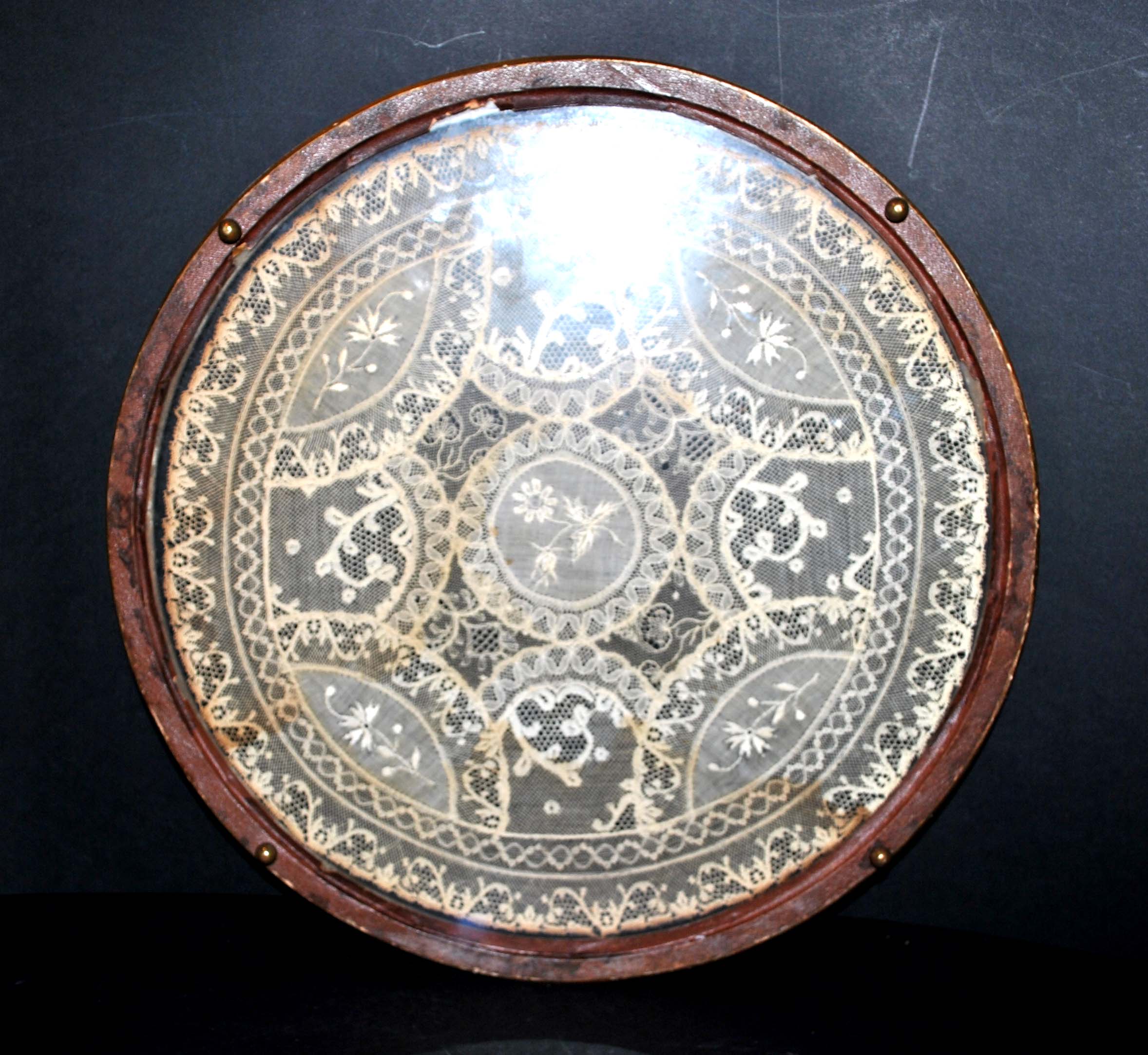 Antique lace top under glass and gilded stucco frame