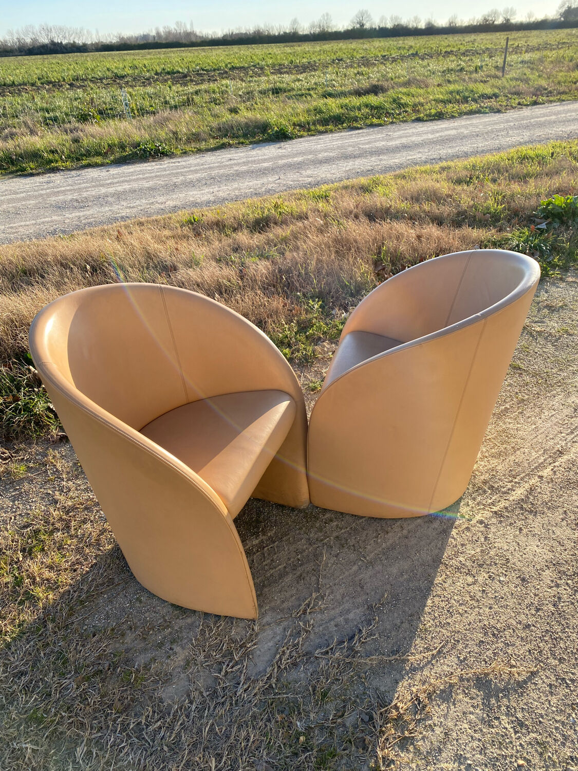 Pair of designer leather armchairs