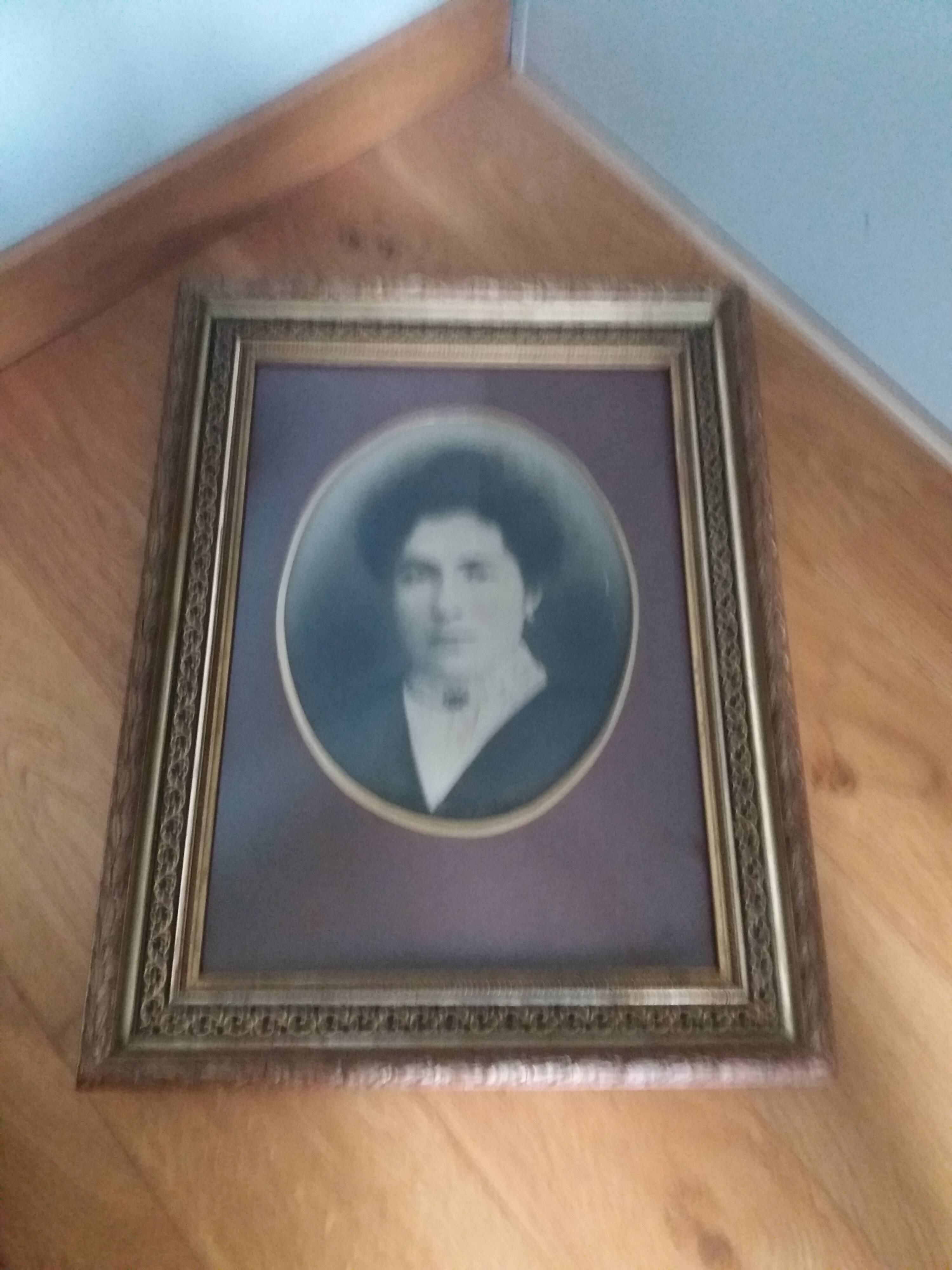 Old photo portrait framed in wood and stucco
