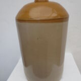 Old wiskhey jug in sand