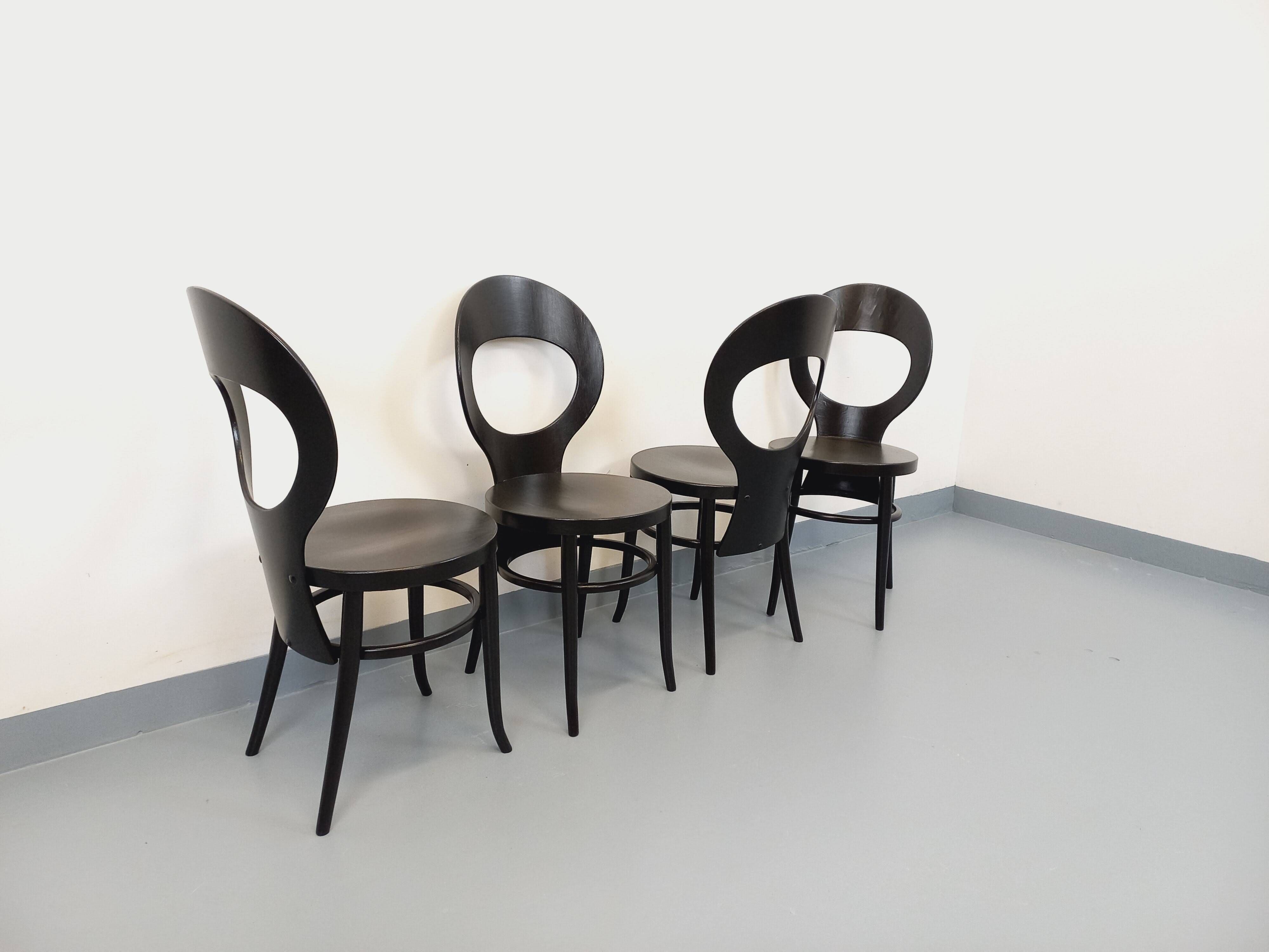 Set of 4 vintage Mouette chairs by Baumann in black wood from the 1960s.