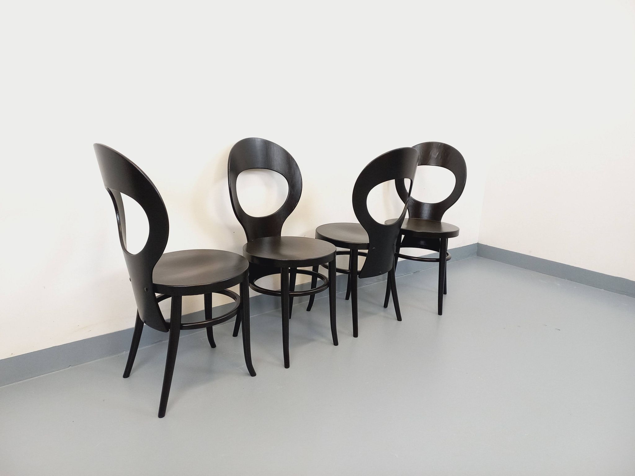 Set of 4 vintage Mouette chairs by Baumann in black wood from the 1960s.