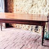 Old French farmhouse table in walnut with turned legs.