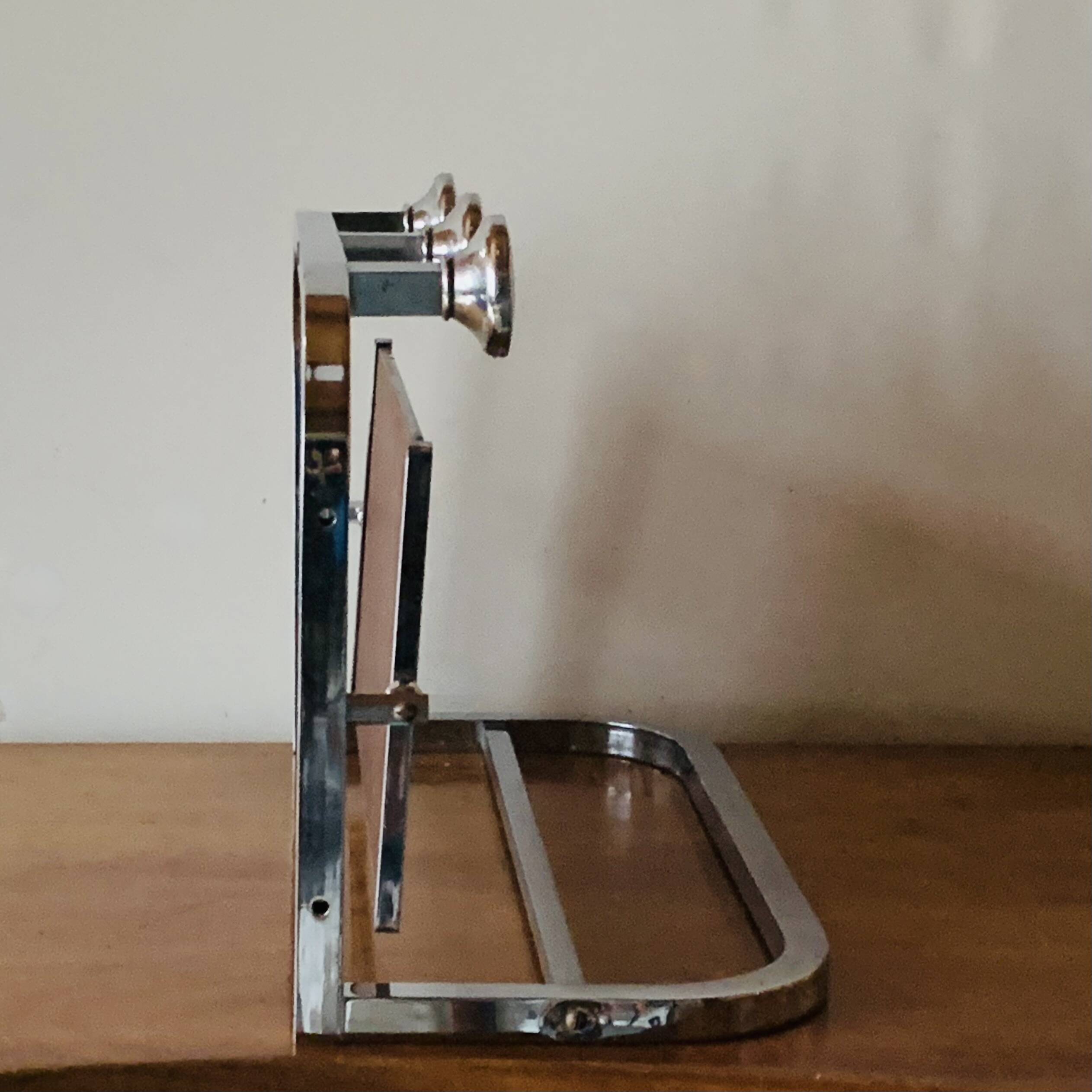 Vintage wall-mounted coat rack in chrome metal with integrated mirror and hat rack