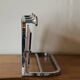 Vintage wall-mounted coat rack in chrome metal with integrated mirror and hat rack