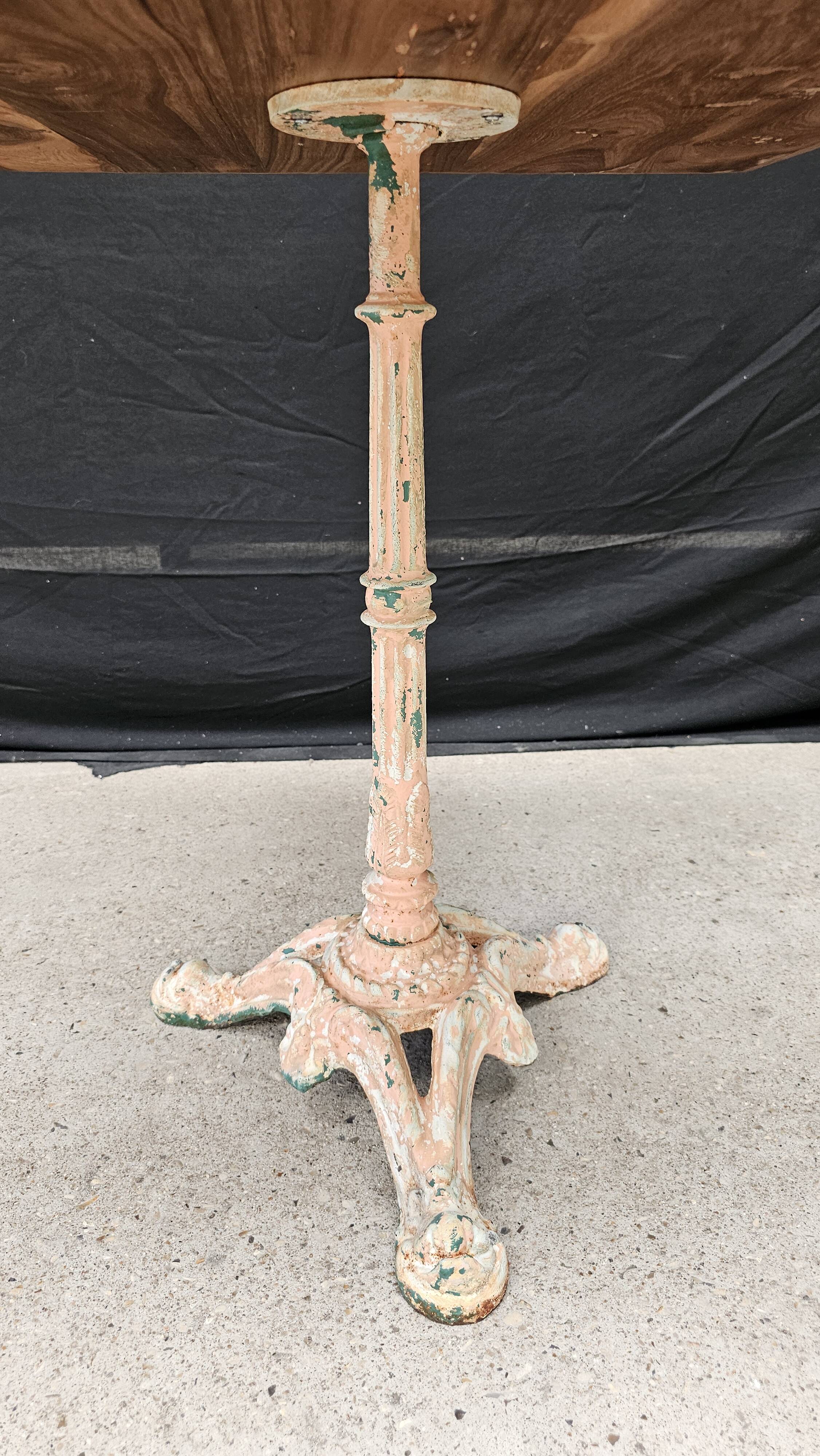 Bistro table with cast iron base and solid teak top