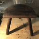 Wooden milking stool on tripod base