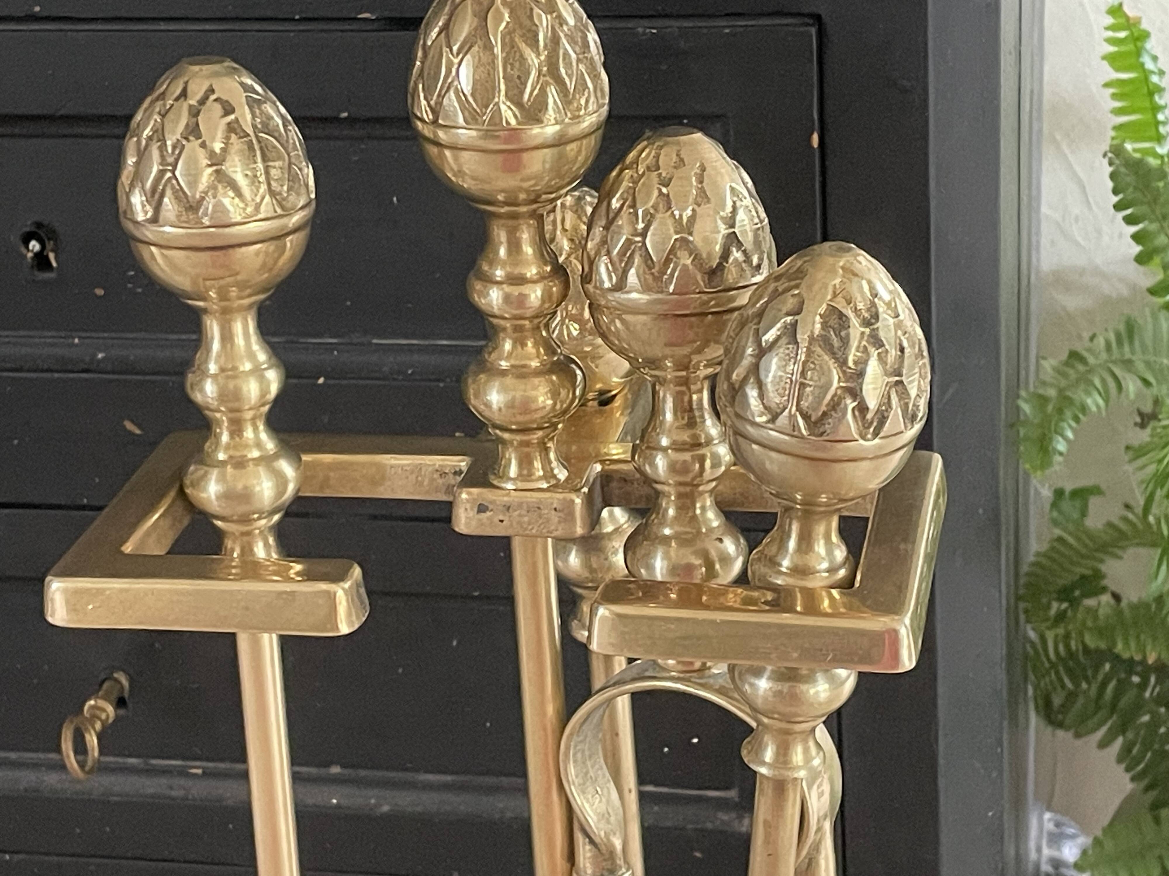 Brass fireplace tools in the style of Maison Baguès.
