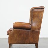 Large sheep leather wingback chair correctly finished with decorative nails