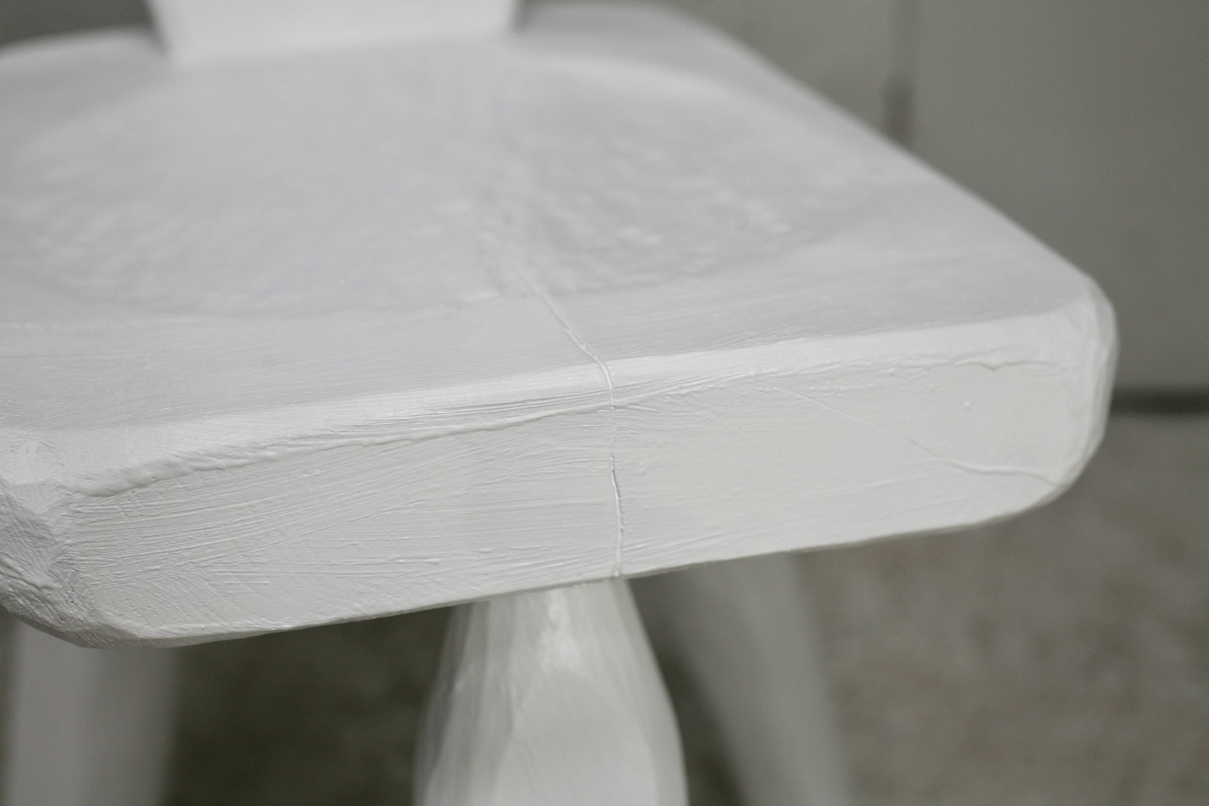 Pair of tripod chairs, gouged seats. Brutalist, circa 1960. Painted wood.