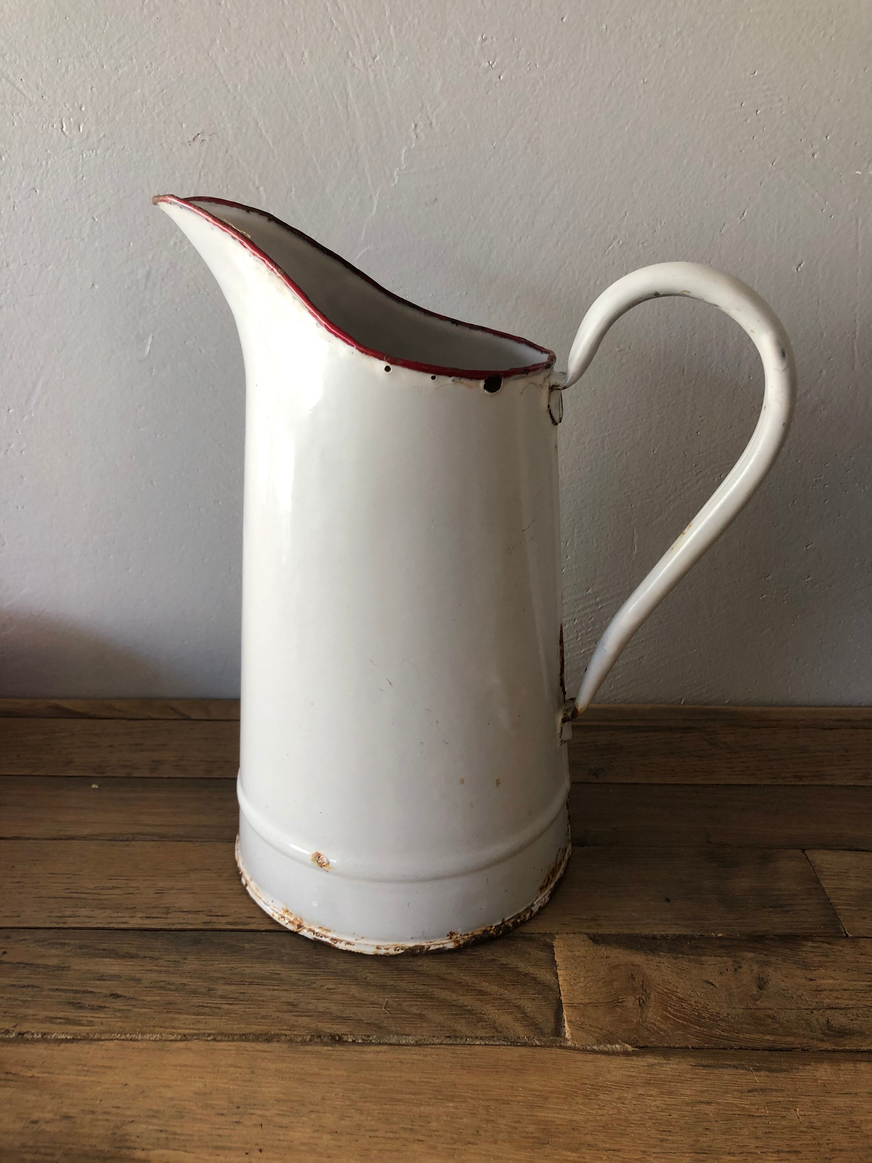 Old pitcher in enamelled sheet metal