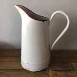 Old pitcher in enamelled sheet metal