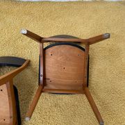 4 Scandinavian chairs in teak and black faux leather.