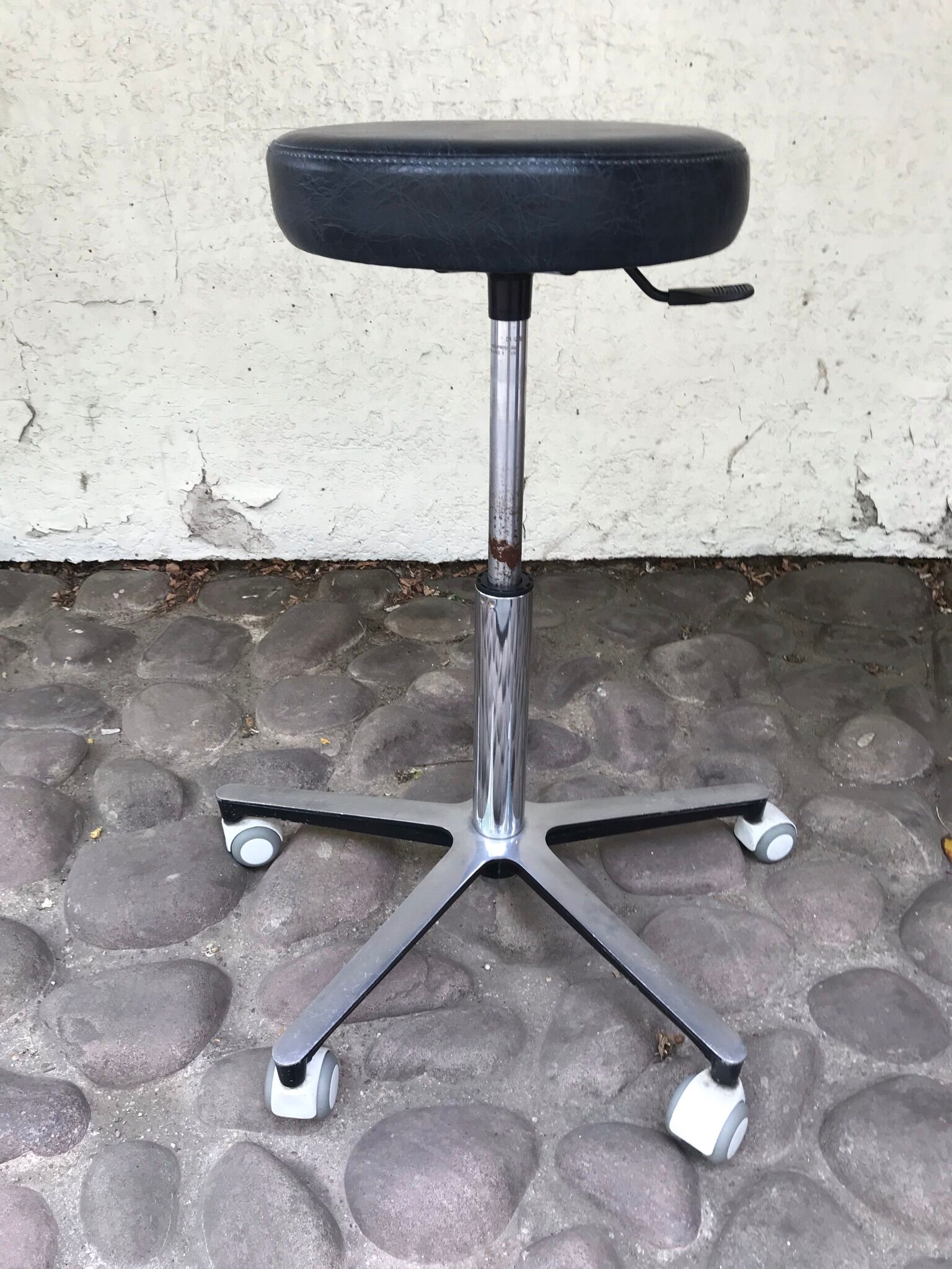 Stool on metal stand in star on wheels sitting round padded skaï bluish