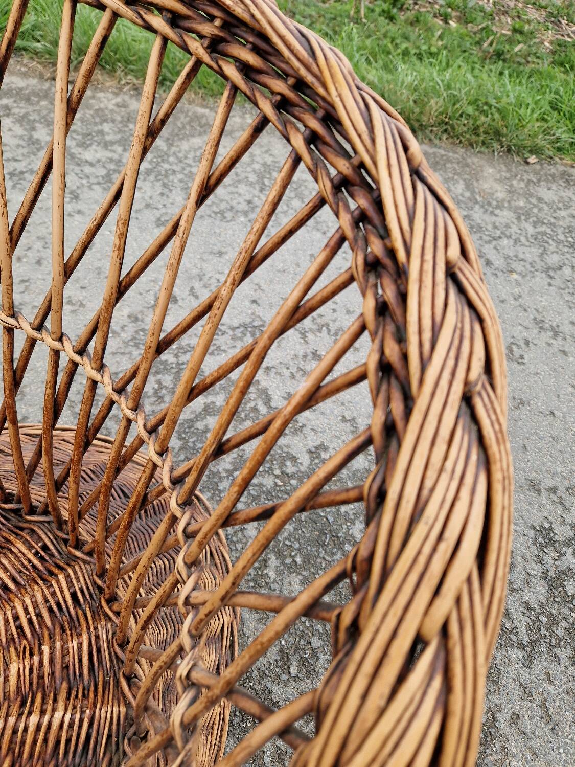 Old throne basket armchair in woven wicker