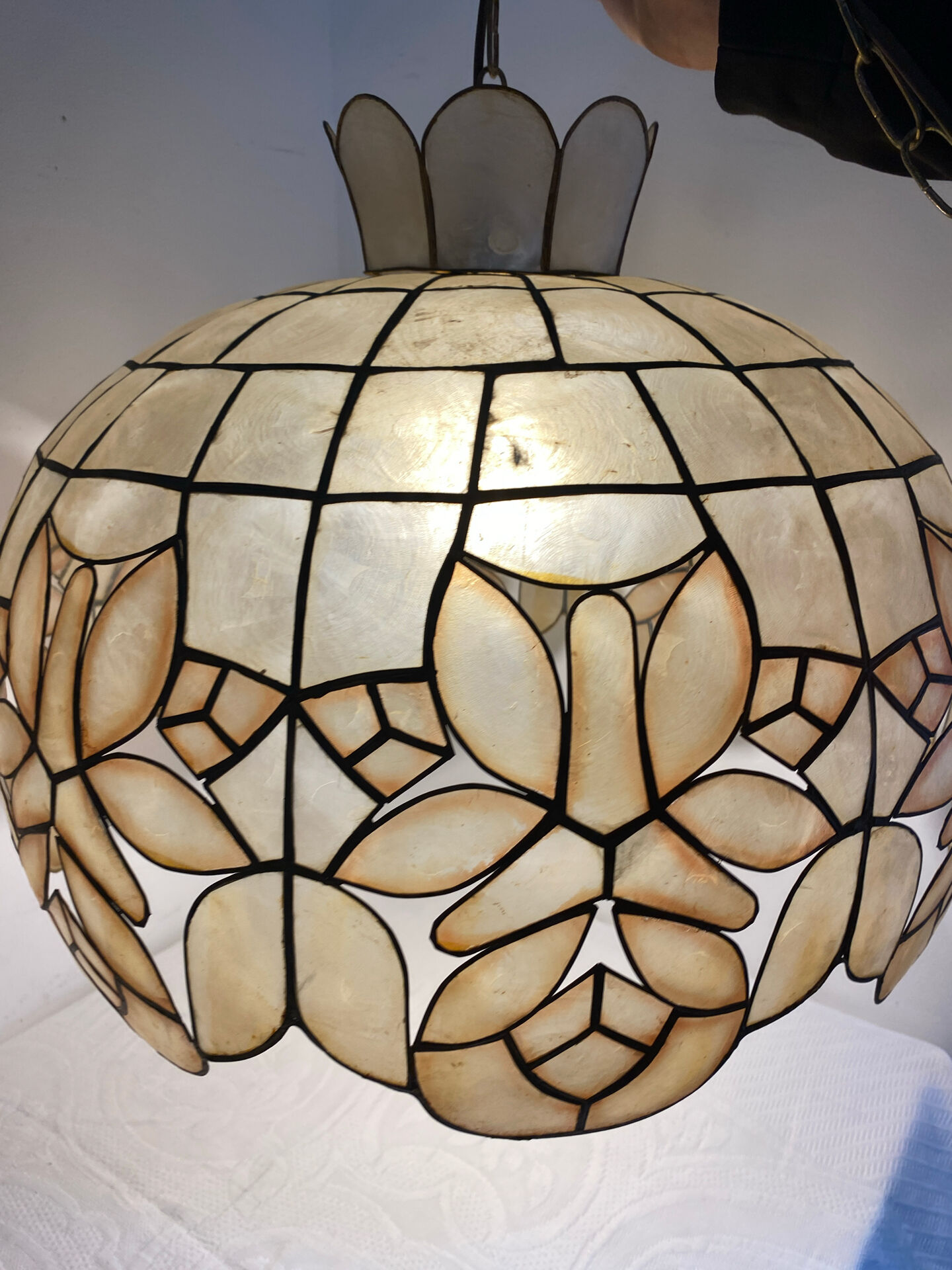 Large mother-of-pearl and brass chandelier with floral decoration.