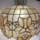Large mother-of-pearl and brass chandelier with floral decoration.