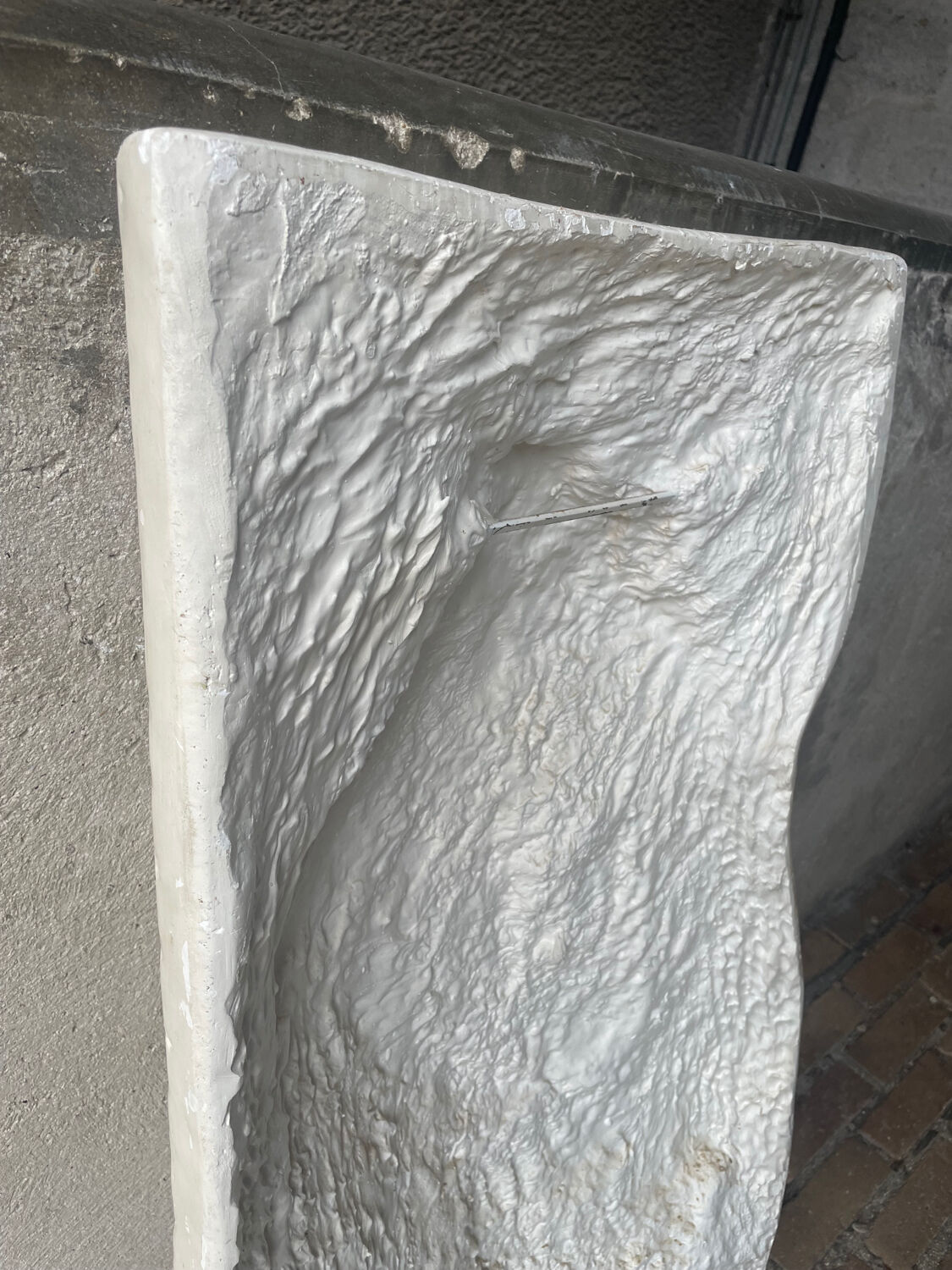 Ancient plaster bas-relief of Nike fastening her sandal.