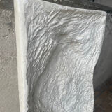 Ancient plaster bas-relief of Nike fastening her sandal.